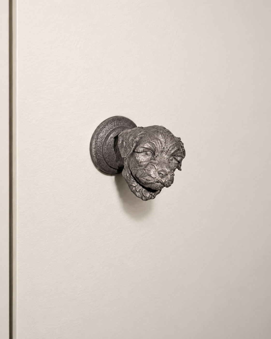 Cat-head cabinet knob on a cream cabinet