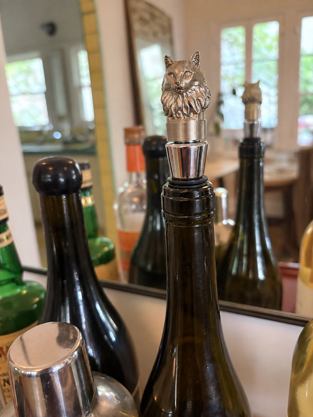 Cat wine stopper in a bottle on a mirrored bar